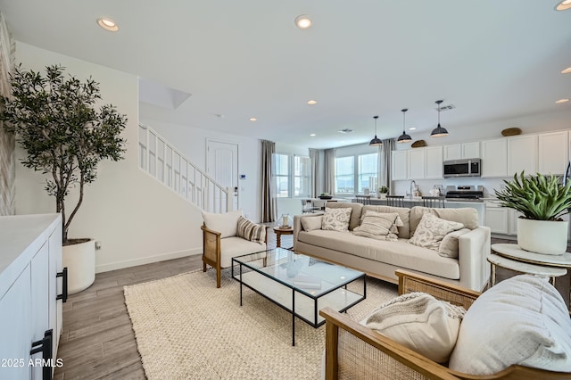 10047 E Ulysses Ave, Mesa, AZ 85212 - living area featuring stairway, light wood finished floors, and recessed lighting