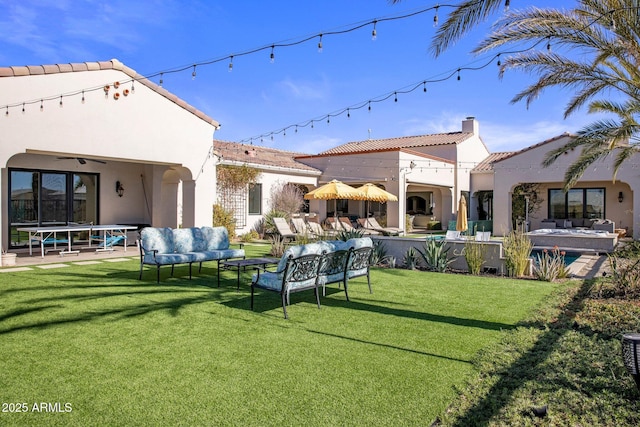 exterior space with a trampoline, a yard, outdoor lounge area, and a patio