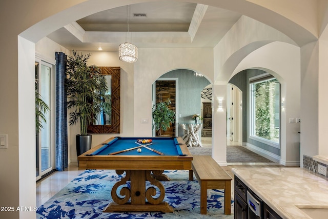 game room with billiards and a raised ceiling