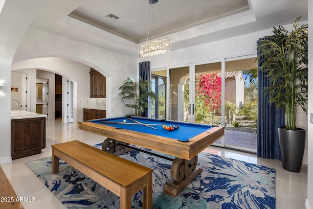 rec room featuring a raised ceiling, crown molding, light tile patterned floors, and billiards