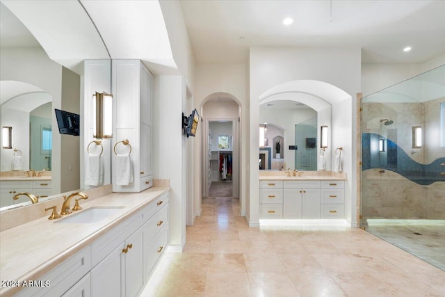 bathroom with vanity and tiled shower