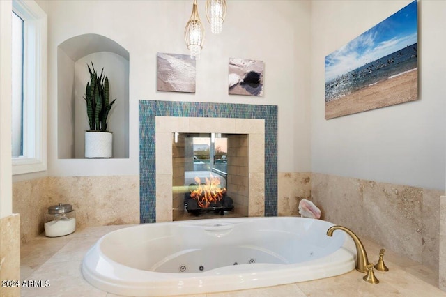 bathroom featuring tiled tub and a fireplace