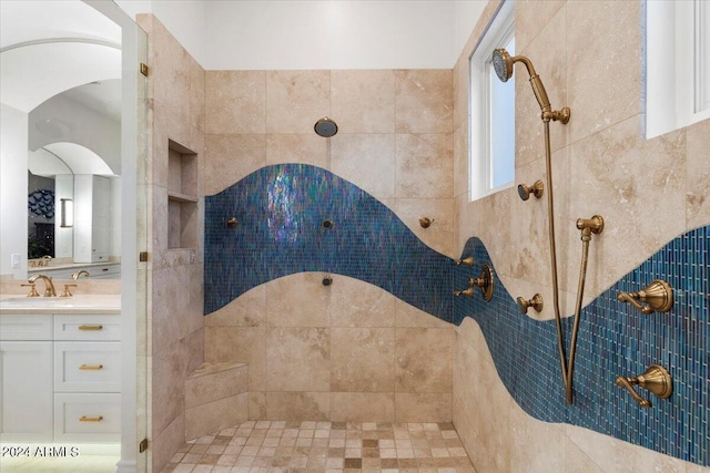 bathroom with vanity and tiled shower