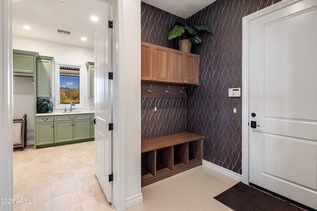 mudroom with sink and light tile patterned floors