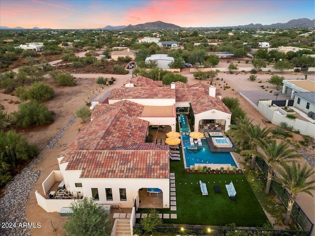 aerial view at dusk featuring a mountain view