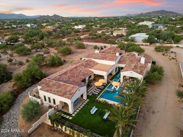 aerial view at dusk featuring a mountain view