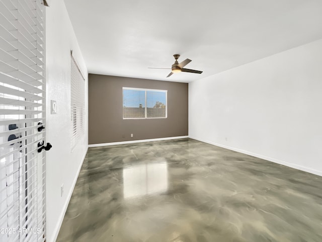 unfurnished room featuring ceiling fan, concrete floors, and baseboards