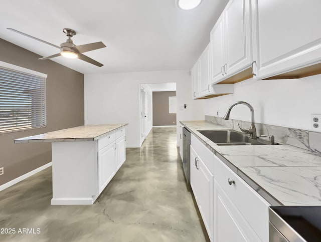 kitchen featuring white cabinets, light countertops, a sink, and a center island