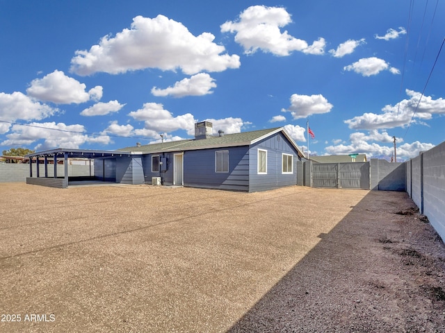 rear view of house with a gate, a fenced backyard, and central air condition unit