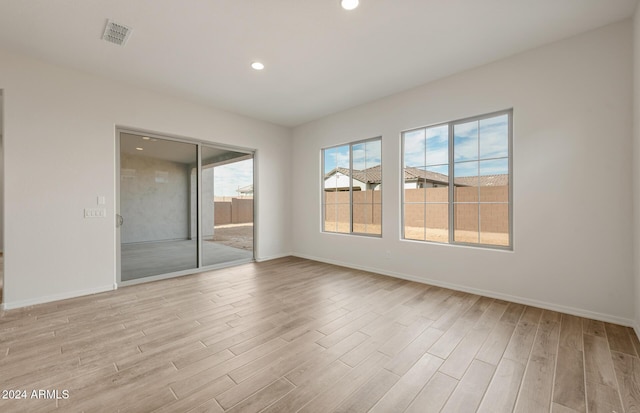 unfurnished room with light hardwood / wood-style floors