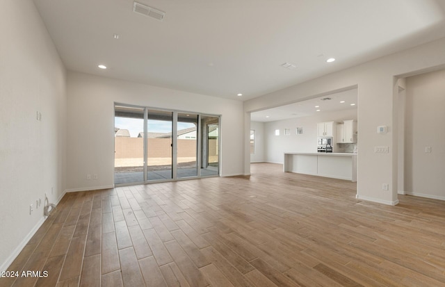 unfurnished living room featuring light wood-type flooring