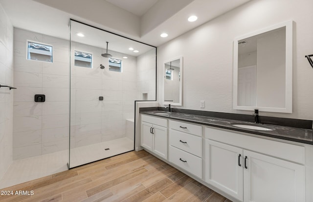 bathroom with vanity and a tile shower