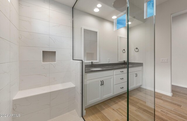 bathroom featuring vanity and tiled shower