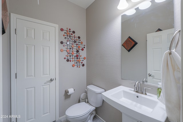 bathroom with toilet and sink