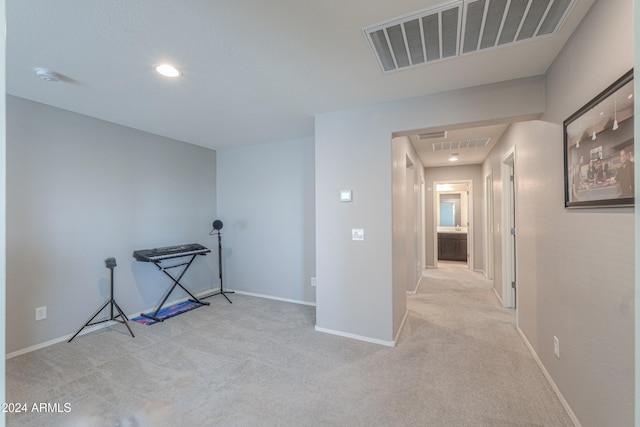 corridor with light colored carpet