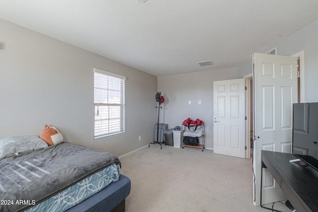 bedroom featuring light carpet