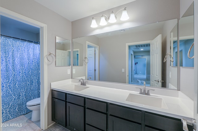 bathroom with tile patterned floors, vanity, and toilet