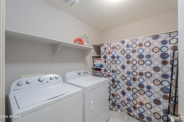 washroom featuring separate washer and dryer and a textured ceiling