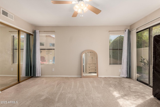 unfurnished room with visible vents, baseboards, and carpet floors