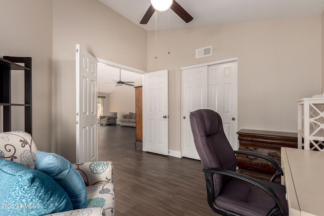 office space featuring dark wood finished floors, a ceiling fan, visible vents, and high vaulted ceiling