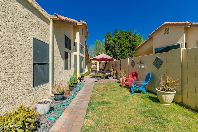 view of yard with a patio and a fenced backyard