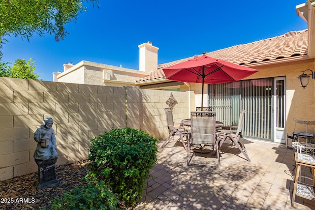 view of patio / terrace featuring outdoor dining area and fence