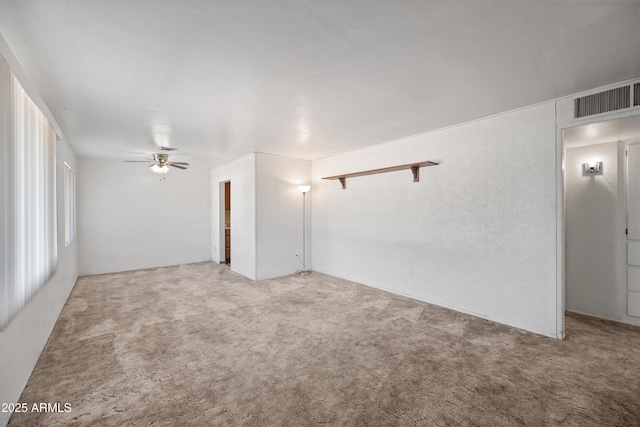 carpeted spare room with ceiling fan