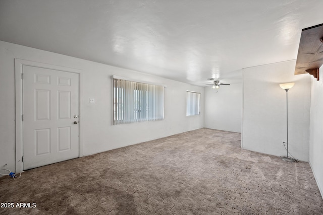 interior space with ceiling fan and carpet flooring