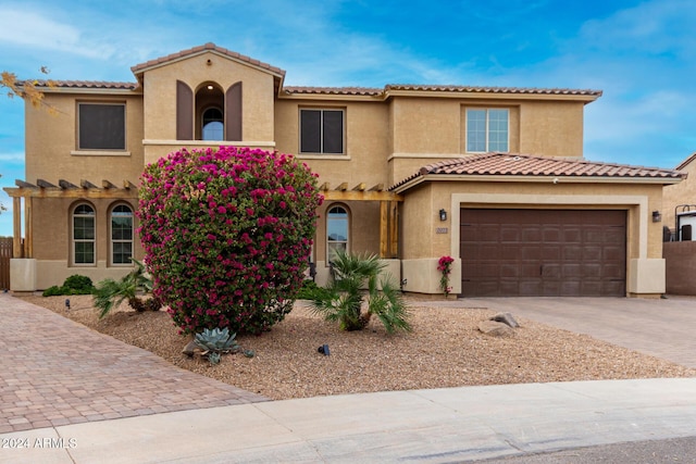 mediterranean / spanish home with a garage