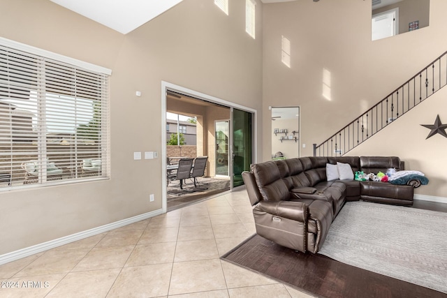 living room featuring light tile patterned floors and a high ceiling