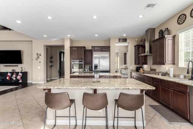 kitchen featuring appliances with stainless steel finishes, a kitchen island with sink, and sink