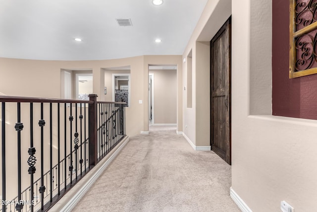 hall featuring light colored carpet