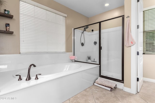 bathroom featuring tile patterned floors and shower with separate bathtub