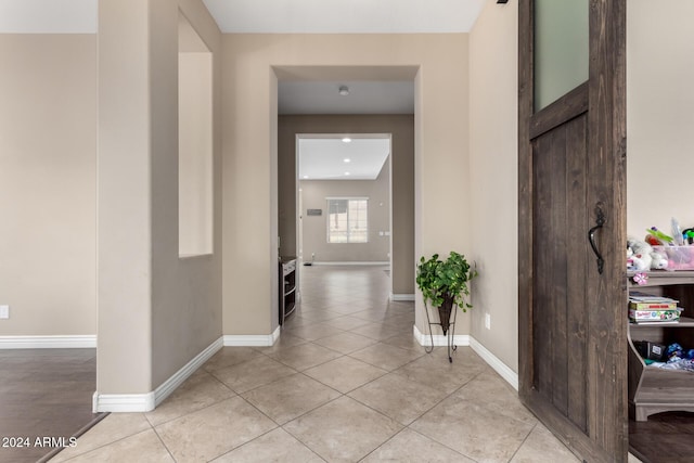 hallway featuring light tile patterned floors