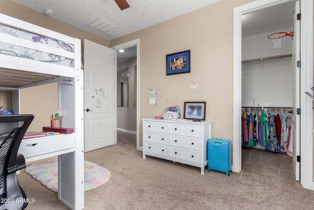 carpeted bedroom featuring a closet and ceiling fan