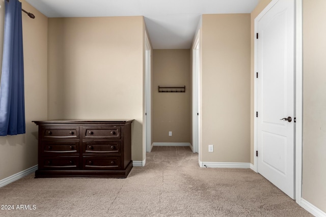 unfurnished bedroom featuring light carpet