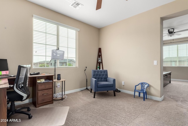 carpeted office featuring ceiling fan