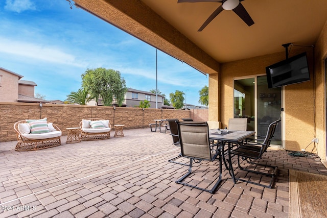 view of patio with outdoor lounge area and ceiling fan