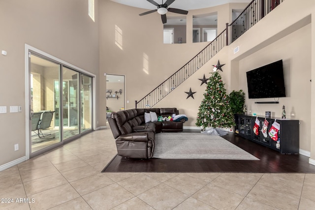 tiled living room featuring a towering ceiling and ceiling fan