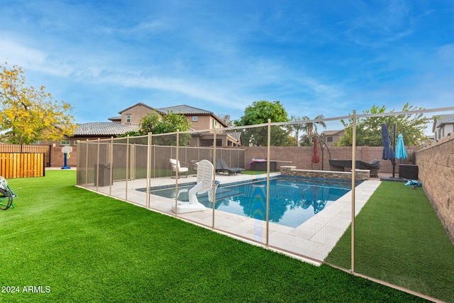 view of swimming pool featuring a patio area and a yard