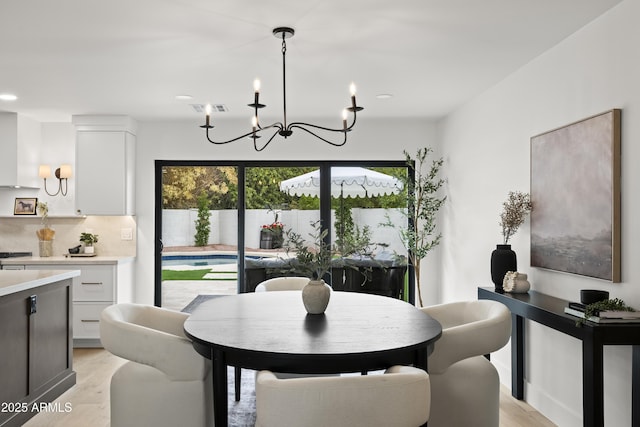 dining space featuring light wood finished floors, visible vents, and recessed lighting