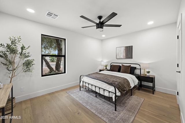 bedroom with recessed lighting, visible vents, a ceiling fan, wood finished floors, and baseboards