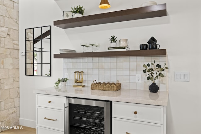 bar featuring a dry bar, beverage cooler, tasteful backsplash, and wood finished floors