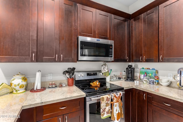 kitchen with light stone countertops and stainless steel appliances