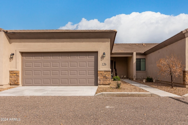 pueblo-style home featuring a garage