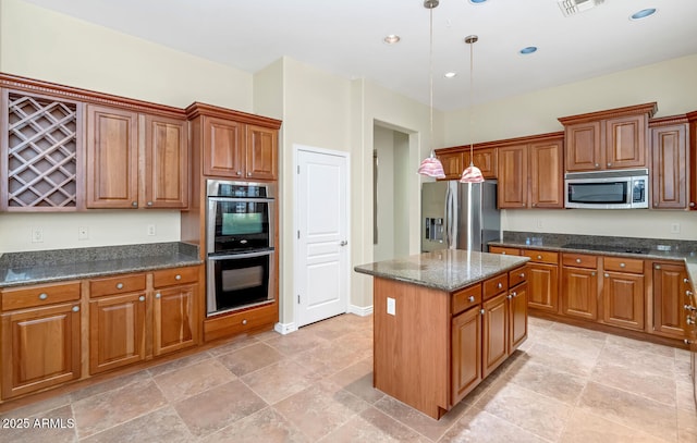 kitchen with brown cabinets, a kitchen island, stainless steel appliances, and decorative light fixtures