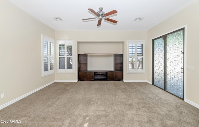 unfurnished living room featuring light carpet, baseboards, visible vents, and a ceiling fan