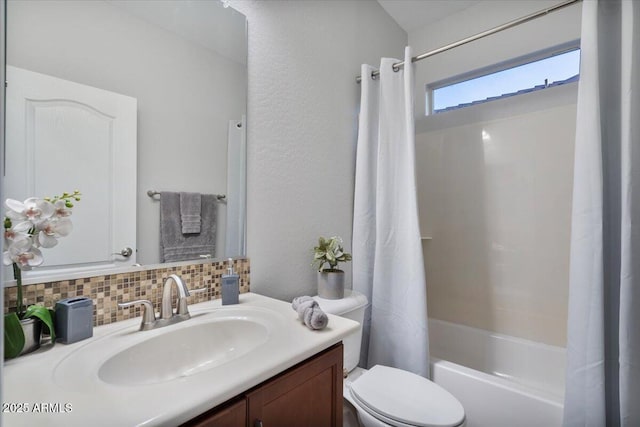 full bathroom featuring toilet, decorative backsplash, vanity, and shower / bath combo with shower curtain