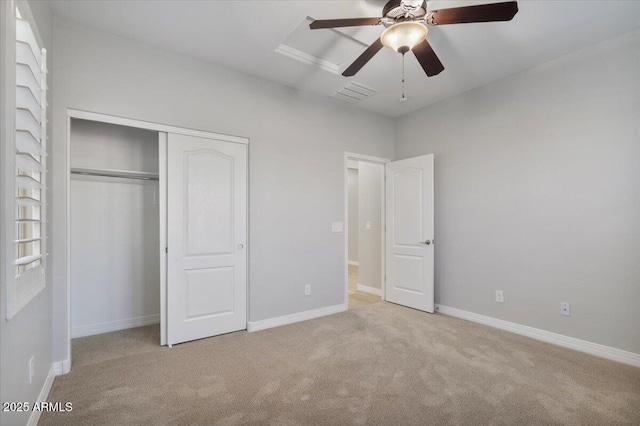 unfurnished bedroom with light carpet, ceiling fan, and a closet