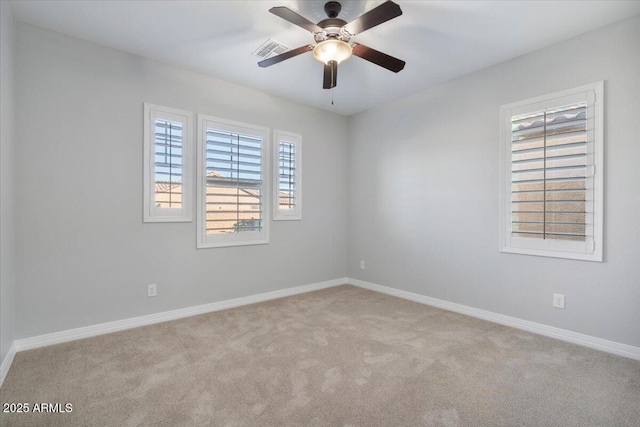 carpeted spare room with ceiling fan